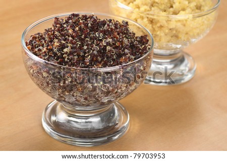 Cooked red and white quinoa in glass bowls which can be eaten as a side dish like rice and is rich in proteins (Selective Focus, Focus on the front of the red quinoa)