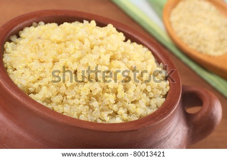 Cooked white quinoa in rustic bowl which can be eaten as a side dish like rice and is rich in proteins (Selective Focus, Focus on the front of the quinoa in the bowl)