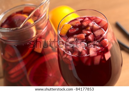 stock photo : Refreshing red wine punch called sangria mixed with orange, apple, mango pieces served in wine glass (Selective Focus, Focus on the fruit pieces in the middle of the glass)