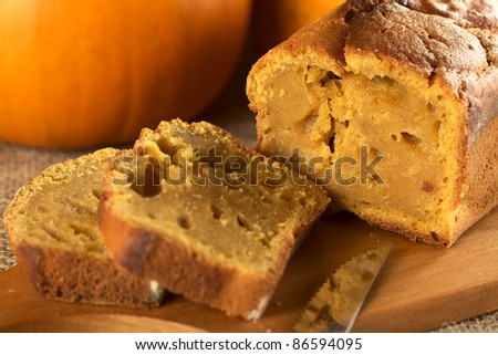Fresh baked pumpkin bread cut in slices on wooden board (Selective Focus, Focus around the crack in the cake)