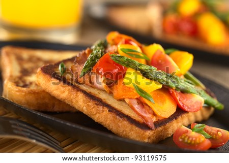 Baked asparagus, mango, tomato, carrot and bacon sandwich on wholewheat toast bread (Selective Focus, Focus on the two asparagus tips in the middle of the image)