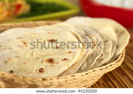 Indian flat-bread called chapati in basket (Selective Focus, Focus on the big brown spot on the front of the first chapati)