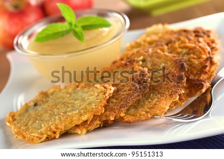 Potato fritters with apple sauce (Selective Focus, Focus on the front edge of the fritters in the front)
