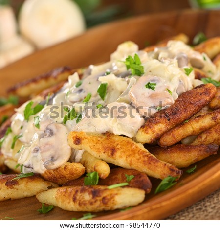 Schupfnudeln (Swabian potato noodles from Southern Germany) with mushroom sauce (Selective Focus, Focus on the front of the mushroom sauce)