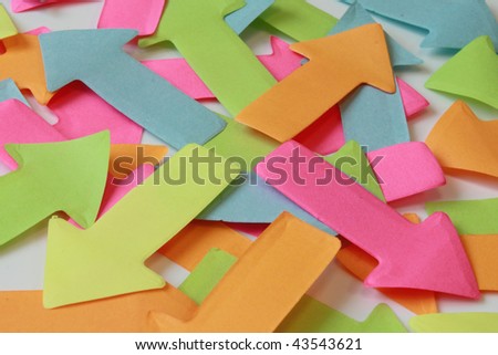 Different direction business concept. Many different colors paper arrows pointing different directions.