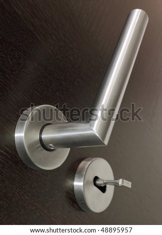 Modern door handle and key. Security concept.