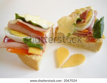 Delicious gourmet sandwich with ham, eggs, mayonnaise, salad, cheese and ketchup. Heart of cheese.