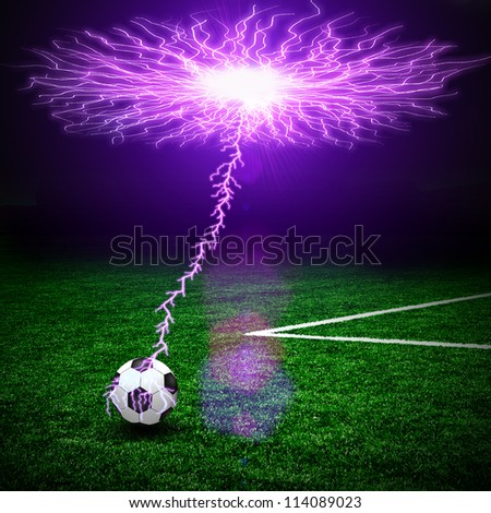 Soccer ball on the green field and lightning