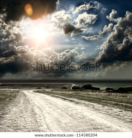 road and fields on the background of the beautiful sky
