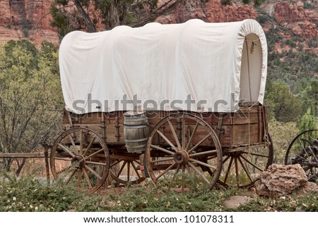 Nice old covered wagon in Arizona, red rock background