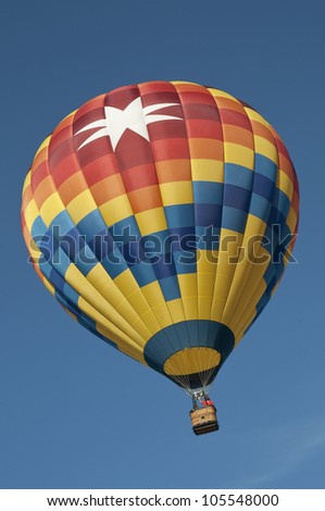 Looking up at beautiful hot air balloon against a nice blue sky