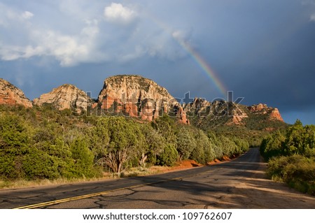 Scenic road with red rock formations and rainbow, Sedona, Arizona, monsoon season