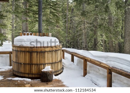 Nice wooden hot tub covered with snow, winter background, northern california