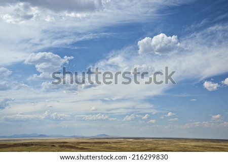 Big Arizona sky near Winslow, flat desert landscape with hills in the distant