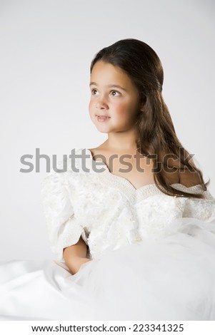 Little girl playing dress up with adult wedding dress, 7 yrs old, brunette