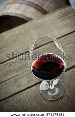 Looking down on wine glass sitting on old wooden box, Cabernet wine