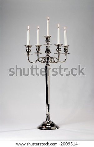 tall silver candelabra with five lit candles