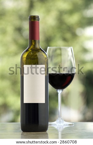 open wine bottle and glass, on marble surface, outdoors background
