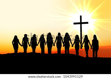 Sunset silhouette of 10 young women walking hand in hand towards the light and a Christian Cross.