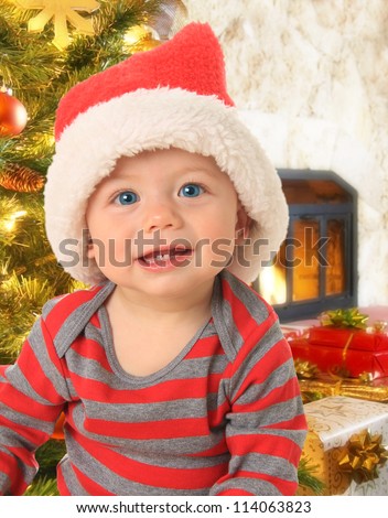 Adorable ten month old baby boy wearing a Santa hat.