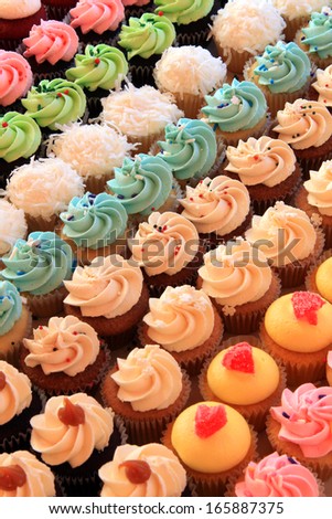 Tray of colorful mini cupcakes