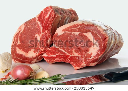 Prime rib raw beef roast on white.