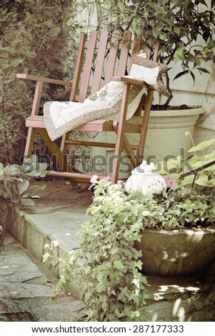Rocking chair in a cottage garden setting. Double exposure with texture layer and instagram filter.