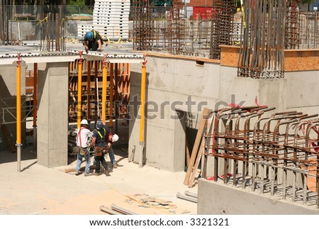 Four men at work at a highrise construction site.