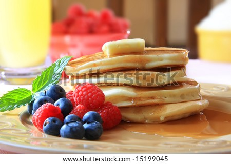 Fresh golden pancakes with summer berries.