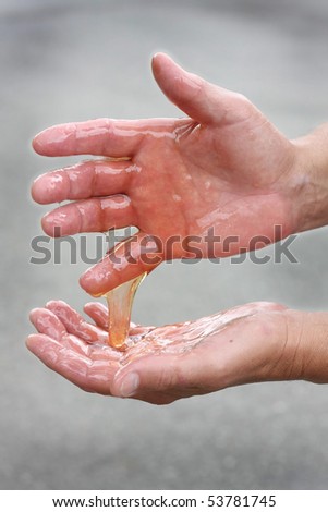 Man\'s hands covered in oil. Oil spill concept.