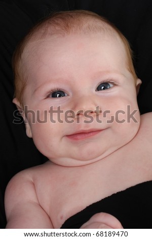 Three month old smiling baby boy portrait.
