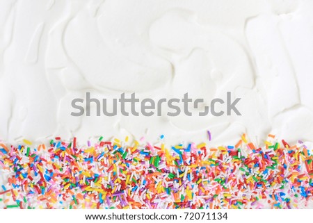 Sugar sprinkles on a white icing background.