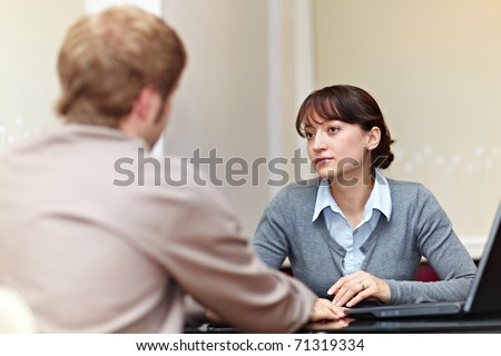 Good looking boss talking to her employee