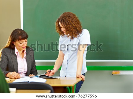 Teacher asking student at the school board and she is showing something