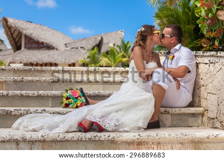 Bride and groom sitting on the steps.