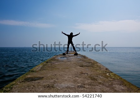 a  man jumps at a sea