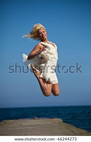 a beautiful blonde woman jump
