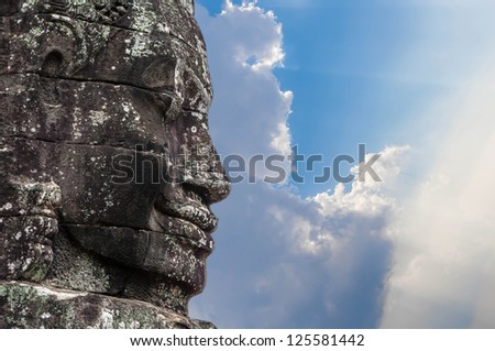A fragment of the towers of the temple of Angkor Thom with the image of the Buddha