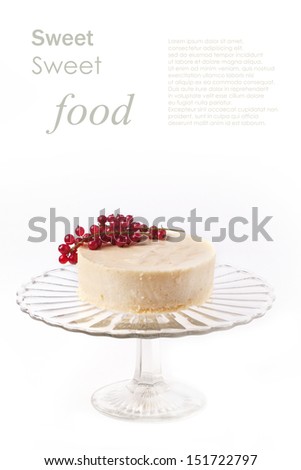 White mousse cake with redcurrant on a glass plate isolated with sample text