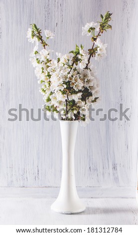 Bouquet of apple flowers on white wooden table