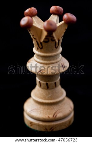 white chess queen isolated on a black background