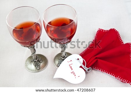 luxury wine glasses with red napkin and valentine heart