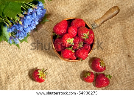 fresh strawberry with bouquet of cornflower