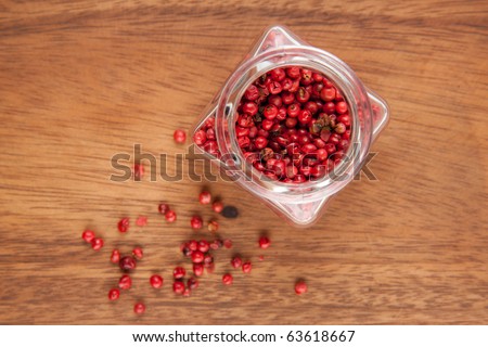 Pot of rose pepper on the wooden table