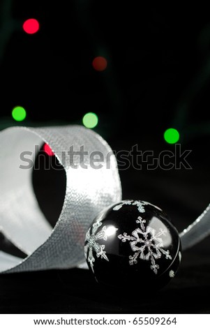 Black christmas ball with the white snowflake on the black background