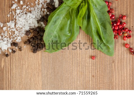 Border os fresh herbs, salt and pepper\'s mix on wooden background