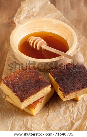 Homemade honey cakes with wooden bowl of honey