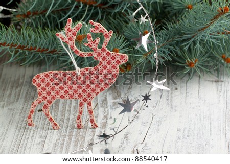 White-red christmas deer with a christmas tree and silver stars