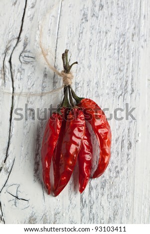 Red hot chili peppers on white wooden table. Available on dark wood.