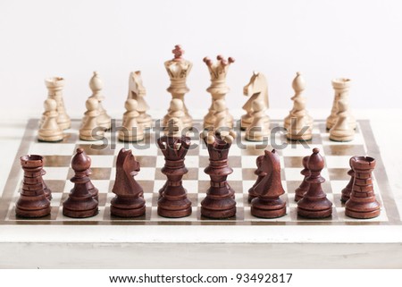 Black and white chess figures on chess desk